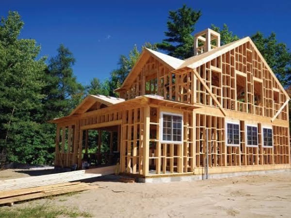A house under construction, framing exposed
