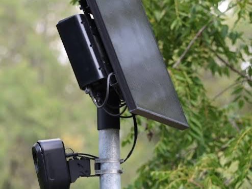 An automated license plate reader mounted on a pole